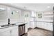 Bright kitchen featuring white cabinets, stainless steel appliances, granite countertops, and wood-look flooring at 225 N Lee St, Mount Holly, NC 28120