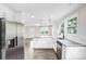Spacious kitchen with stainless steel appliances, granite counters, white cabinets, and wood-look flooring at 225 N Lee St, Mount Holly, NC 28120