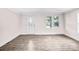 Bright living room with luxury vinyl flooring and decorative front door and multiple windows at 225 N Lee St, Mount Holly, NC 28120