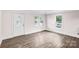 Bright living room with luxury vinyl flooring, a decorative front door, and abundant natural light at 225 N Lee St, Mount Holly, NC 28120