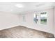 Bright living room with luxury vinyl flooring, a decorative front door, and abundant natural light at 225 N Lee St, Mount Holly, NC 28120