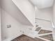 Bright stairway with wood-grain treads leading to a second level and a laundry area with hookups at 225 N Lee St, Mount Holly, NC 28120