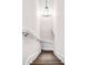 Upward shot of a stairway with wood-grain treads, white risers and handrails and a decorative chandelier at 225 N Lee St, Mount Holly, NC 28120