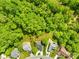 An aerial view shows homes nestled in a lush, green, mature tree canopy at 229 River Birch Cir, Mooresville, NC 28115