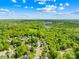 Aerial view shows a neighborhood with mature trees, green spaces, and a distant radio tower at 229 River Birch Cir, Mooresville, NC 28115