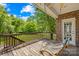 Inviting back porch with a relaxing hammock swing, wooden deck, and tranquil backyard view at 229 River Birch Cir, Mooresville, NC 28115