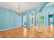 Formal dining room featuring elegant chandelier lighting, hardwood floors, and bright sunlight at 229 River Birch Cir, Mooresville, NC 28115