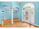 Stunning foyer with hardwood floors, arched doorway, chandelier and large front door with transom window at 229 River Birch Cir, Mooresville, NC 28115
