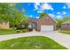 Charming brick home featuring an attached two-car garage, blue front door, and manicured landscaping at 229 River Birch Cir, Mooresville, NC 28115