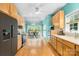 Eat-in kitchen with stainless steel appliances, wood cabinets, and hardwood floors at 229 River Birch Cir, Mooresville, NC 28115