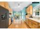 Eat-in kitchen with stainless steel appliances, wood cabinets, and hardwood floors at 229 River Birch Cir, Mooresville, NC 28115