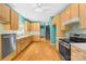 Modern kitchen features stainless steel appliances, tile backsplash, and light wood cabinets at 229 River Birch Cir, Mooresville, NC 28115