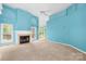 Bright living room with a cozy fireplace, large windows, and neutral carpeting at 229 River Birch Cir, Mooresville, NC 28115