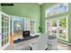 Inviting office space with large windows, a modern desk setup, and a view into other parts of the home at 229 River Birch Cir, Mooresville, NC 28115
