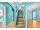 Staircase with carpet runner, light wood railing, and teal walls, connecting the home's levels with style at 229 River Birch Cir, Mooresville, NC 28115