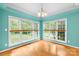 Bright sunroom with beautiful hardwood floors and large windows overlooking the backyard at 229 River Birch Cir, Mooresville, NC 28115