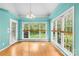 Cozy sunroom with natural light, hardwood floors, and views of the yard at 229 River Birch Cir, Mooresville, NC 28115