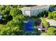 Aerial view of a community tennis court and playground, surrounded by greenery and buildings at 245 Rock Ridge Ln, Mount Holly, NC 28120
