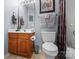 Well-maintained bathroom with a wooden vanity, framed mirror, and a shower-tub combo at 245 Rock Ridge Ln, Mount Holly, NC 28120