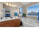 Modern bathroom featuring double vanity, soaking tub, and large window, creating a spa-like retreat at 245 Rock Ridge Ln, Mount Holly, NC 28120
