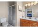 Bright bathroom featuring a double sink vanity, framed mirror, and glass-enclosed shower at 245 Rock Ridge Ln, Mount Holly, NC 28120