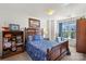 Cozy bedroom with a wooden bed frame, blue bedding, and a bookshelf at 245 Rock Ridge Ln, Mount Holly, NC 28120