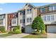 Charming townhome with well-manicured lawn and attached garage on a sunny day at 245 Rock Ridge Ln, Mount Holly, NC 28120