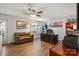 Bright and inviting living room with laminate flooring, a fan, and a cozy seating area at 245 Rock Ridge Ln, Mount Holly, NC 28120