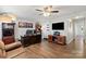 Comfortable living room with wood laminate flooring, a ceiling fan, and neutral decor at 245 Rock Ridge Ln, Mount Holly, NC 28120