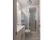 Clean bathroom featuring a sink, toilet, cabinet, and tiled shower with glass doors at 2808 Findley Rd, Statesville, NC 28625