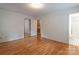 Bedroom with hardwood floors, closet with sliding doors, and an attached bathroom at 2808 Findley Rd, Statesville, NC 28625