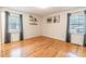 Bright bedroom with hardwood floors, two windows, neutral paint, and floating shelves on the wall at 2808 Findley Rd, Statesville, NC 28625