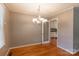 Bright dining room featuring hardwood floors and a modern chandelier, perfect for Gathering meals at 2808 Findley Rd, Statesville, NC 28625