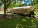 Brick home exterior with lush landscaping and mature trees providing ample shade at 2808 Findley Rd, Statesville, NC 28625