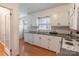 Functional kitchen with white cabinets, and stainless steel appliances, featuring hardwood floors at 2808 Findley Rd, Statesville, NC 28625