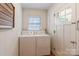 Functional laundry area with a washer, dryer, and a window for natural light at 2808 Findley Rd, Statesville, NC 28625