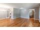Open living room with hardwood floors showcasing seamless flow to the kitchen and other rooms at 2808 Findley Rd, Statesville, NC 28625