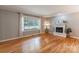 Comfortable living room featuring hardwood floors, a cozy fireplace and a large window at 2808 Findley Rd, Statesville, NC 28625