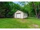 Outdoor shed with a roll-up door and windows, nestled in a green yard at 2808 Findley Rd, Statesville, NC 28625
