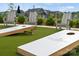 Community cornhole with Adirondack chairs on artificial turf, perfect for outdoor fun at 320 Basil Dr, Indian Trail, NC 28079