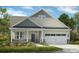 Charming single-story home with a welcoming front porch, stone accents, and a two-car garage at 320 Basil Dr, Indian Trail, NC 28079