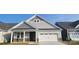 Charming single-Gathering home featuring stone accents, a covered entryway, and an attached two-car garage at 320 Basil Dr, Indian Trail, NC 28079