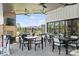 Inviting outdoor patio with comfortable seating, fireplace with TV, and ceiling fans at 320 Basil Dr, Indian Trail, NC 28079