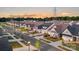 Street view of neighborhood with well-manicured lawns and sidewalks at sunset at 320 Basil Dr, Indian Trail, NC 28079
