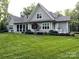 Beautiful home's backyard features a green lawn and lovely landscaping at 3201 Johnny Cake Ln, Charlotte, NC 28226