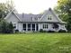 Expansive backyard features a lush lawn and lovely exterior of home at 3201 Johnny Cake Ln, Charlotte, NC 28226