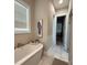 Elegant bathtub complemented by a bright window and view to the closet at 3201 Johnny Cake Ln, Charlotte, NC 28226