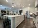 Spacious kitchen with stainless appliances and a large island overlooking the living room at 3201 Johnny Cake Ln, Charlotte, NC 28226