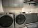 Laundry room with stainless steel appliances, counter space, and storage cabinets at 3201 Johnny Cake Ln, Charlotte, NC 28226