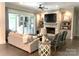 Elegant living room features a cozy fireplace and seamless access to the outdoor kitchen and patio area at 3201 Johnny Cake Ln, Charlotte, NC 28226